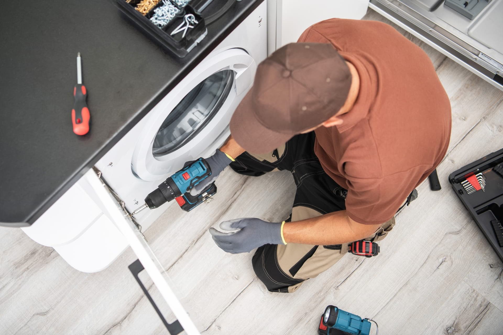 technician repairing washing machine