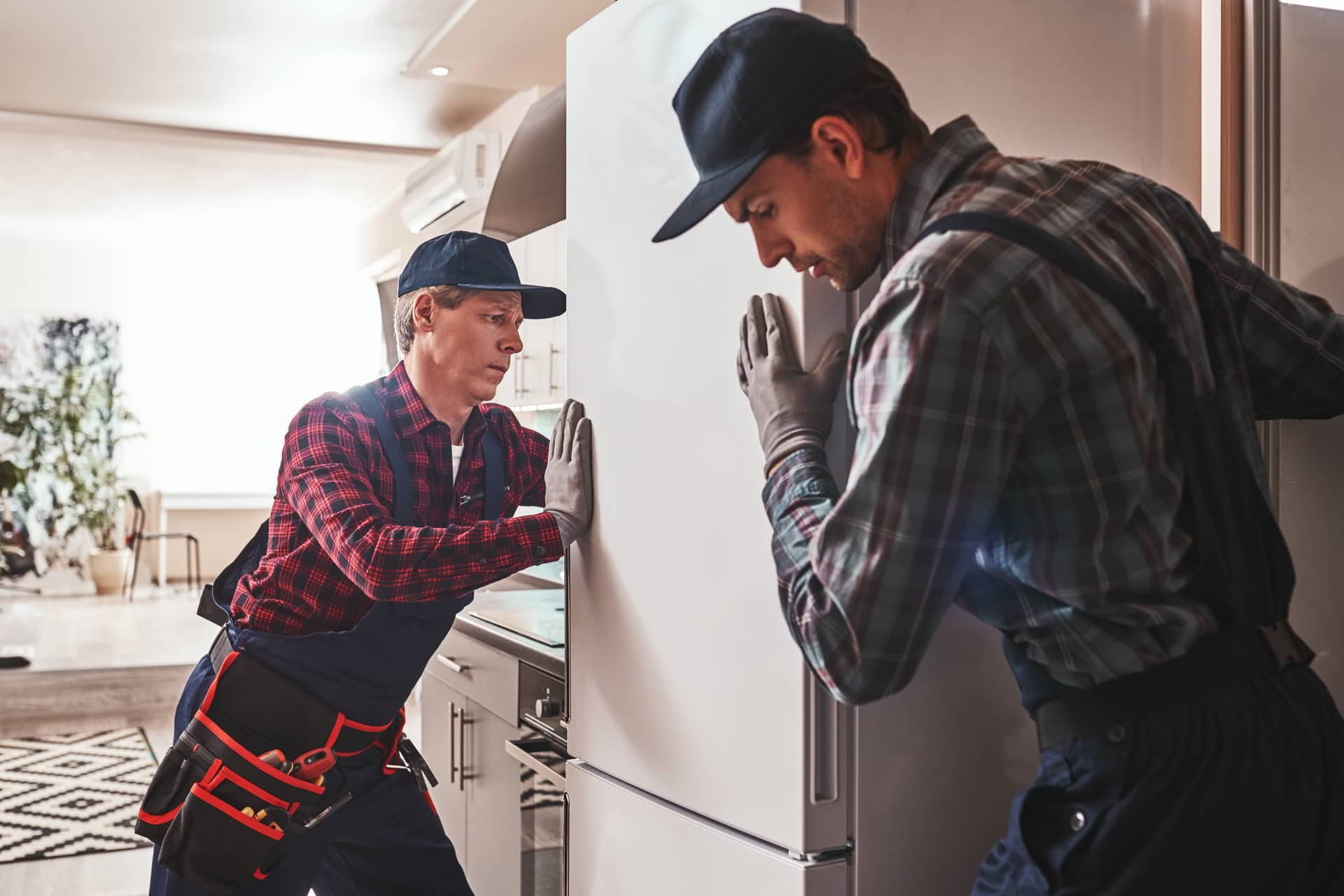 men repairing fridge